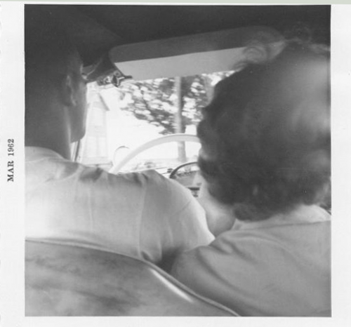 Dad and Mom sitting close in Front Seat of Car - Driving
